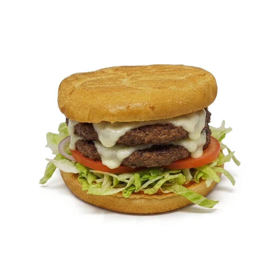 Double cheeseburger with melted cheese, lettuce, tomato, and onion on a sesame-seeded bun.